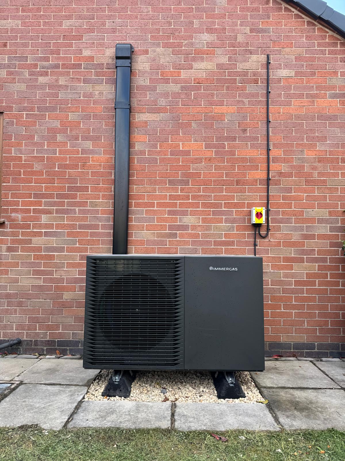 Installed Immergas heat pump with neatly routed insulated pipework